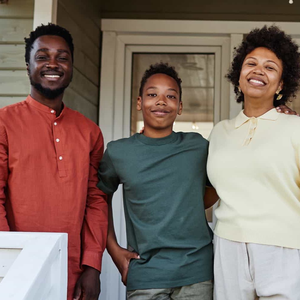 Family of three on a porch smiling