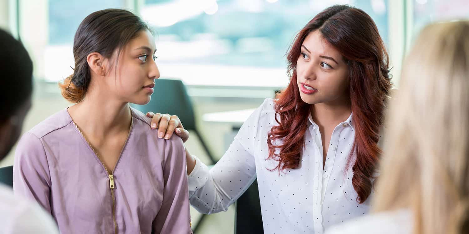 One woman supporting another during a group discussion