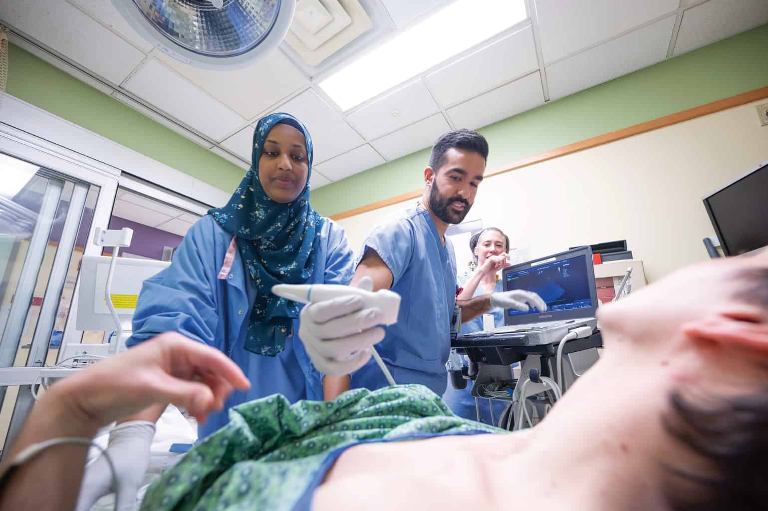 Resident performs an ultrasound on a patient