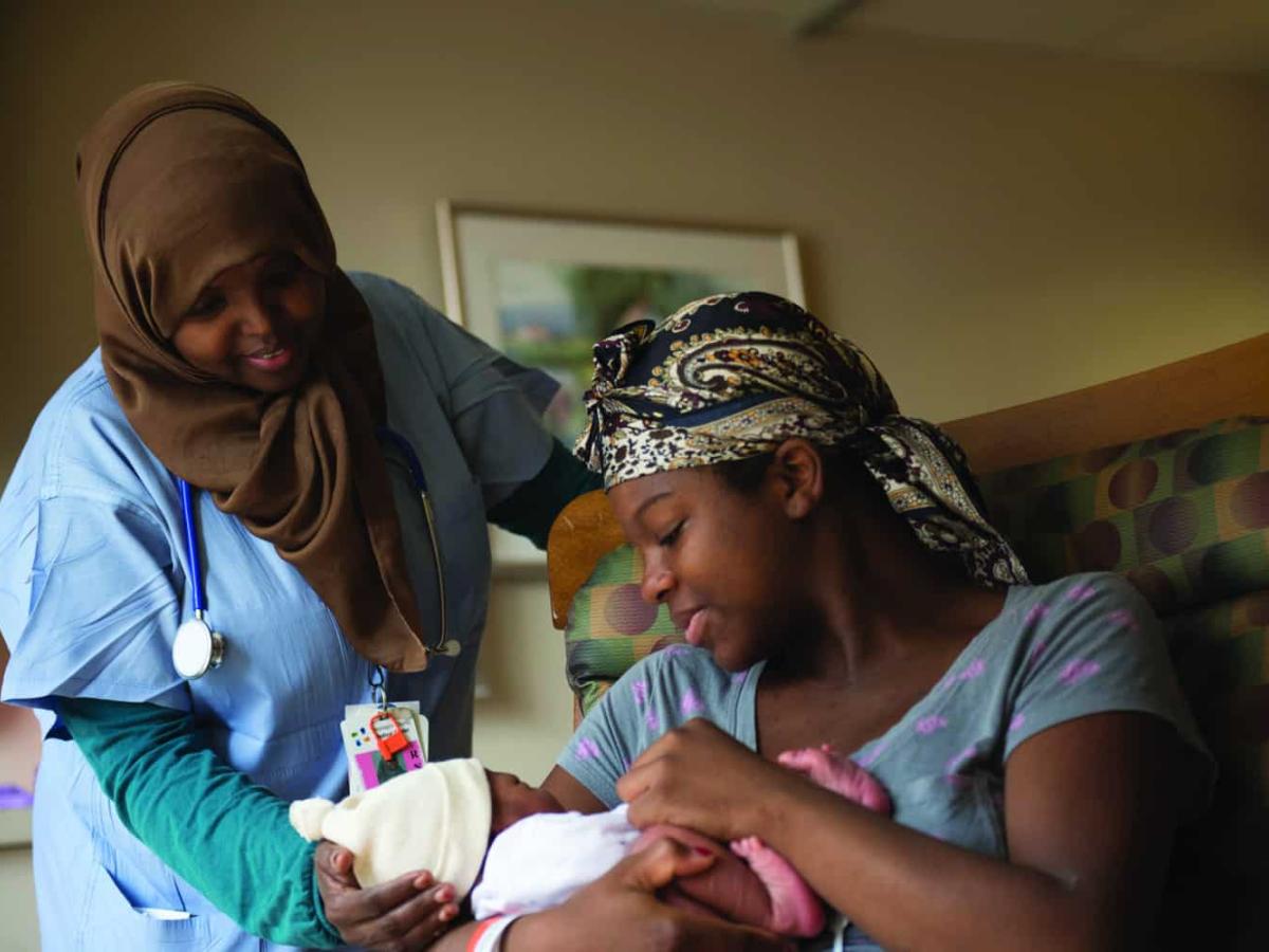 doula and mother with her baby