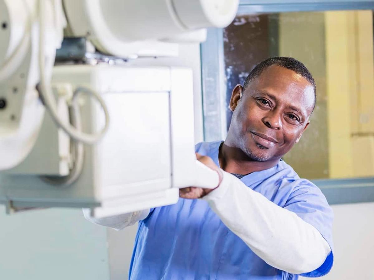 Radiology tech with machine