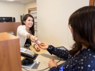 Female Pharmacist handing patient medication