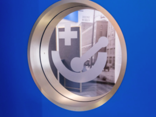 Pharmacy logo in a circle surrounded by a gold and royal blue