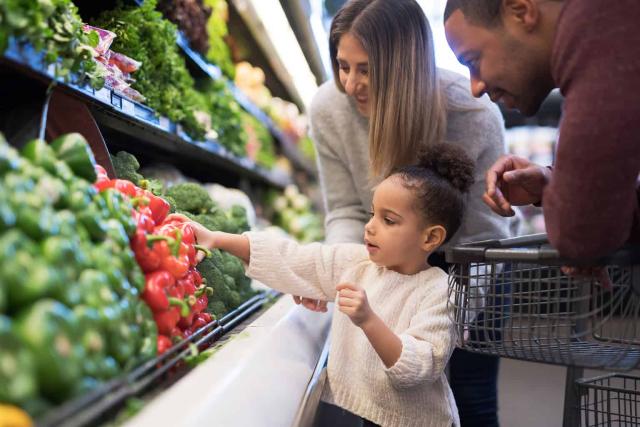 young family in the produce aisle
