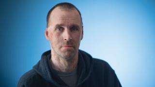 Male in black sweatshirt looking forward