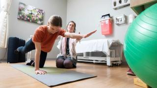 Woman practicing physical therapy movements