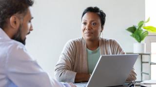 woman and man in a business meeting with a laptop