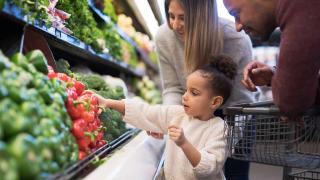young family in the produce aisle