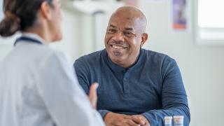 pharmacist with patient discussing his medication protocol