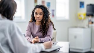 young woman with doctor discussing endometriosis diagnosis