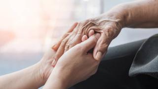 holding an elderly woman's hand closeup