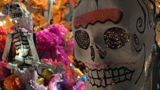 close up view of sugar skulls decorated with glitter and paint for dia de los muertos celebration