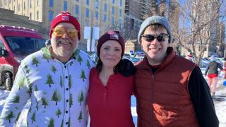 three adults outside