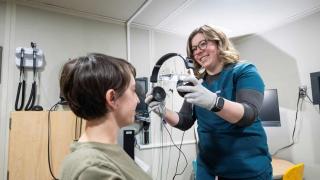 patient with audiologist in clinic