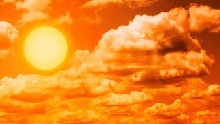 Orange sky with clouds and bright sun showing intense heat, hot, weather, cool, regulate, temperature