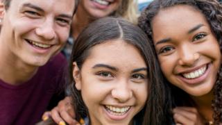 three smiling teens, healthcare that gives adolescents and young adults a voice, rapid socioemotional development, freedom to make decisions, facilitating parent-teen communication, janna gewirtz o’brien