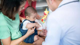 A Little Child And His Family Visit The Doctor For A Routine Health Checkup