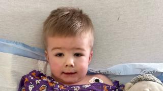 young boy named Crue with a fractured arm in hospital bed