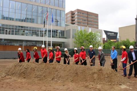 Representatives of Hennepin Healthcare, Hennepin Healthcare Foundation, Sherman Associates, and Homes for Heroes dig in to celebrate the groundbreaking.