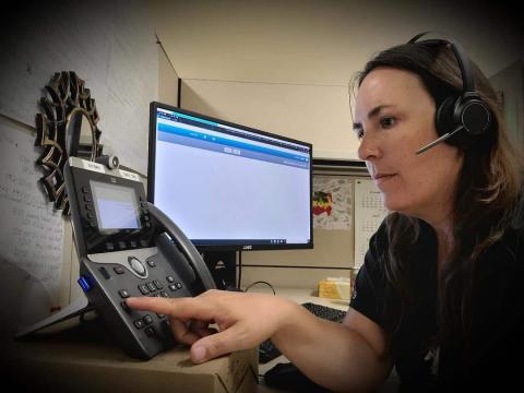 Close-up view of multiple tablet devices docked in charging stations, representing the use of modern technology in healthcare settings.