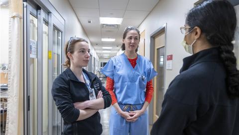 Medical residents in a hallway doing a consult