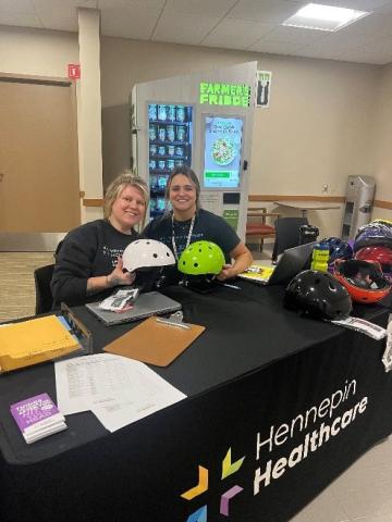 Women holding bicycle helmets
