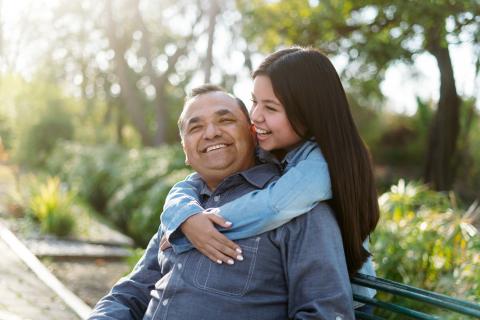 Hispanic dad and daughter smiling