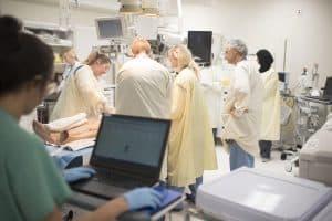 emergency staff member viewing computer and multiple staff members in stabilization room, emergency stabilization room, stab room, level 1 trauma center, critical patients, stabilization room recorder, jack hedberg