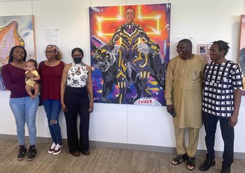 group in front of portrait, hennepin healthcare nurse, nominated for breast cancer superhero, portrait project, breast cancer survivor, breast cancer survivor portrait project