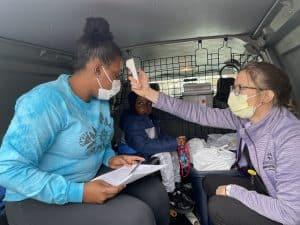 nurse helping patient, mobile clinic brings health care to patients' doors, mobile van healthcare, routine vaccines, pediatric mobile health team, childhood immunizations, bridge a healthcare gap