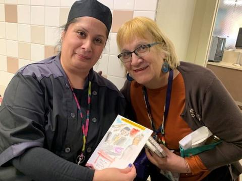 anita white with employee, showing drawing