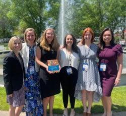 group of women in front of fountain
