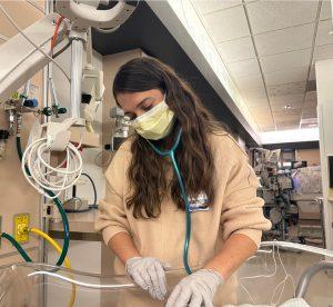 Miller With Patient, A day-in-the-life, NICU Medical Director, Dr. Cristina Miller, pediatrics, Neonatal Intensive Care Unit