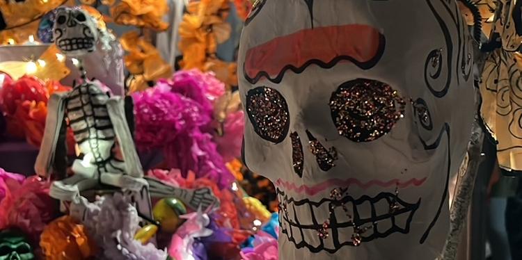 close up view of sugar skulls decorated with glitter and paint for dia de los muertos celebration