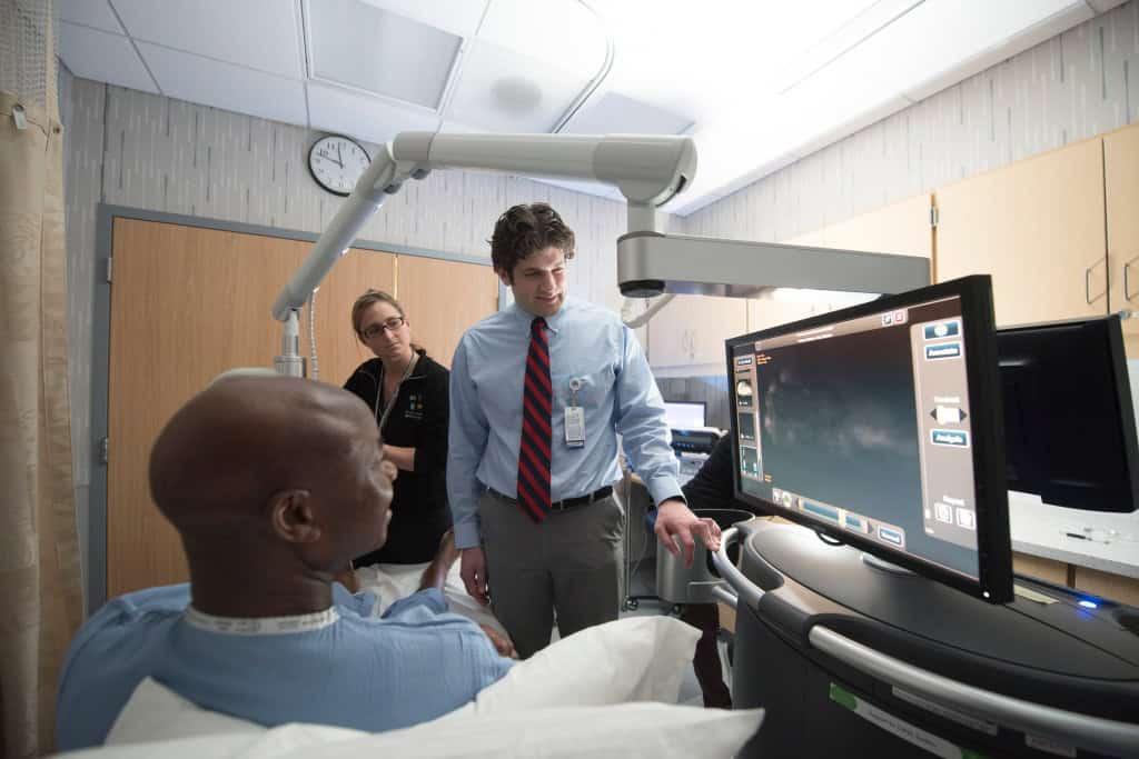 wound healing staff with patient in clinic room, HCMC using real-time blood flow imaging, improve treatment for non-healing wounds, wound healing technology