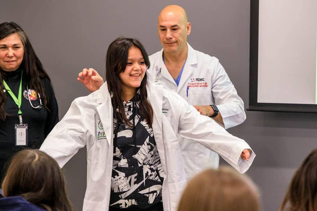 student with ed doc at the American Indian Youth with Stethoscopes summit, American Indian Youth with Stethoscopes, Summit, healthcare careers, doctor, nurse, dentist, paramedic, phlebotomist, cpr, ultrasound, pathology, tribes, 23 tribal affiliations, Talent Garden Summit, medical seminar, youth summit for indian youth