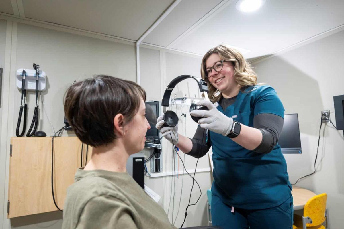 patient with audiologist in clinic