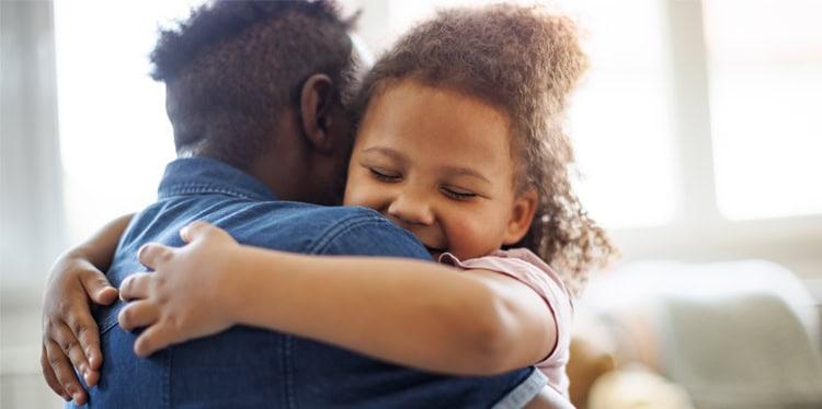 Father daughter embrace with focus on childs happy face, parents, parenting, stress, well-being, mental health, support