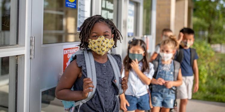 kids with masks outside of school building, back to school, extracurricular activities, ow to stay safe at school during covid19, unstructured downtime for rest, masking and physical distancing, dr jane harris, american academy of pediatrics