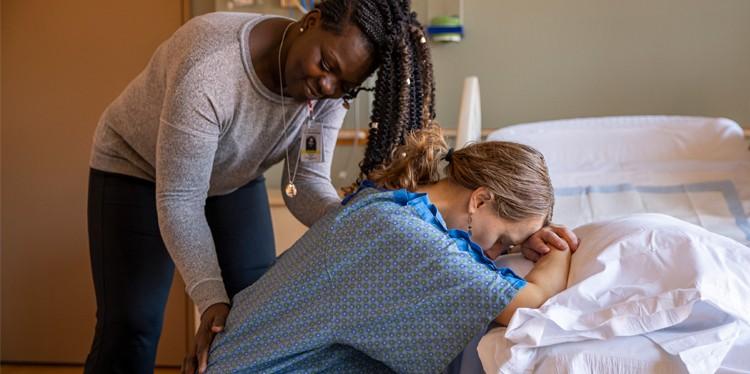 doula helping mom in hospital, what is a doula, midwifes, midwife, support during childbirth, emotional support for moms, claudia beck