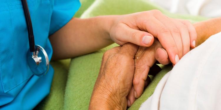 provider holding hand of patient, hospice care, palliative care, comfort care for illness, end of life care, life threatening diseases
