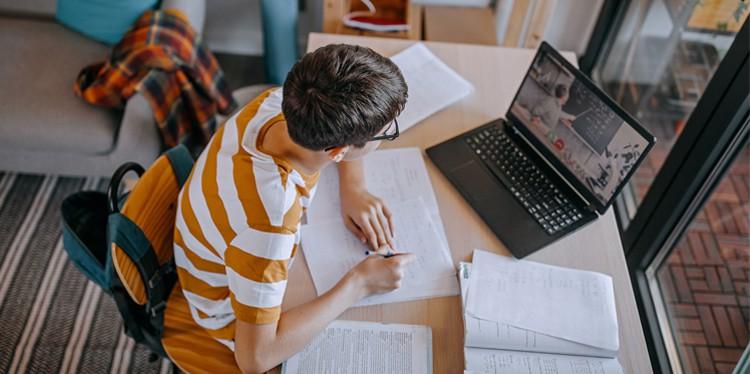 teen looking at computer, back to school for teens, teen anxiety, back to school challenges, tips for easing teen anxiety, parent support for teens