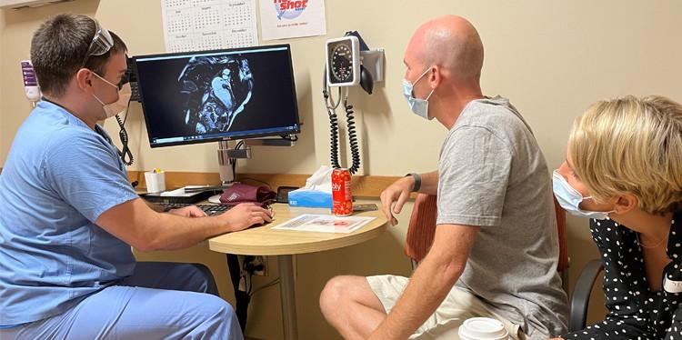 provider with john and his wife in front of xray, young healthy and at risk for a heart attack, vomited several times, burning lungs, heart hurt, 90 percent blockage of left anterior descending artery, michael konstantinides, tombstoning, cardiac rehab program