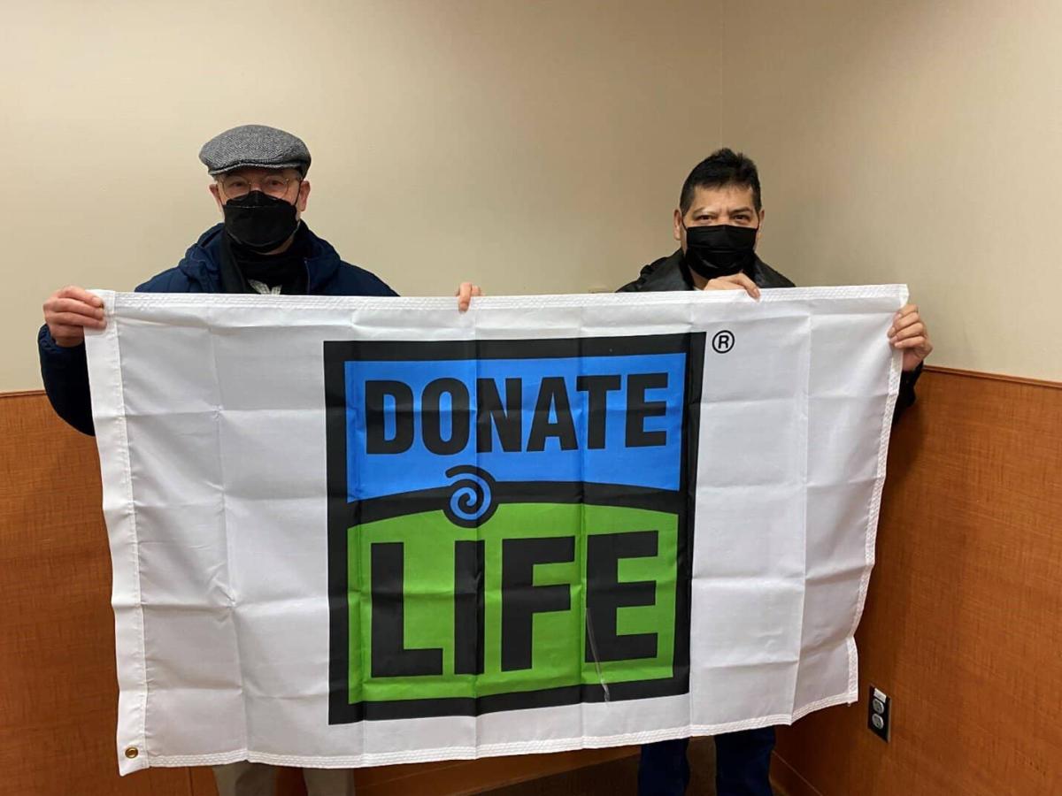Two donors hold up the donate life flag, kidney donor, transplant recipient, donate life, transplant program, non-directed donor, jose amigon tlatenchi