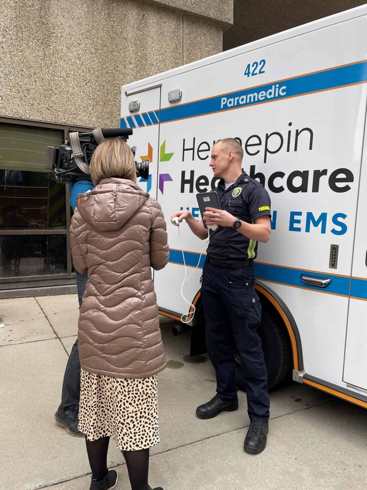paramedic talking to woman next to ambulance, paramedic training adds second chance for retired math teacher, diagnostic ultrasound, pulmonary embolism, blood clot, lifesaving diagnostic technology, p3 paramedics, daniel bowler