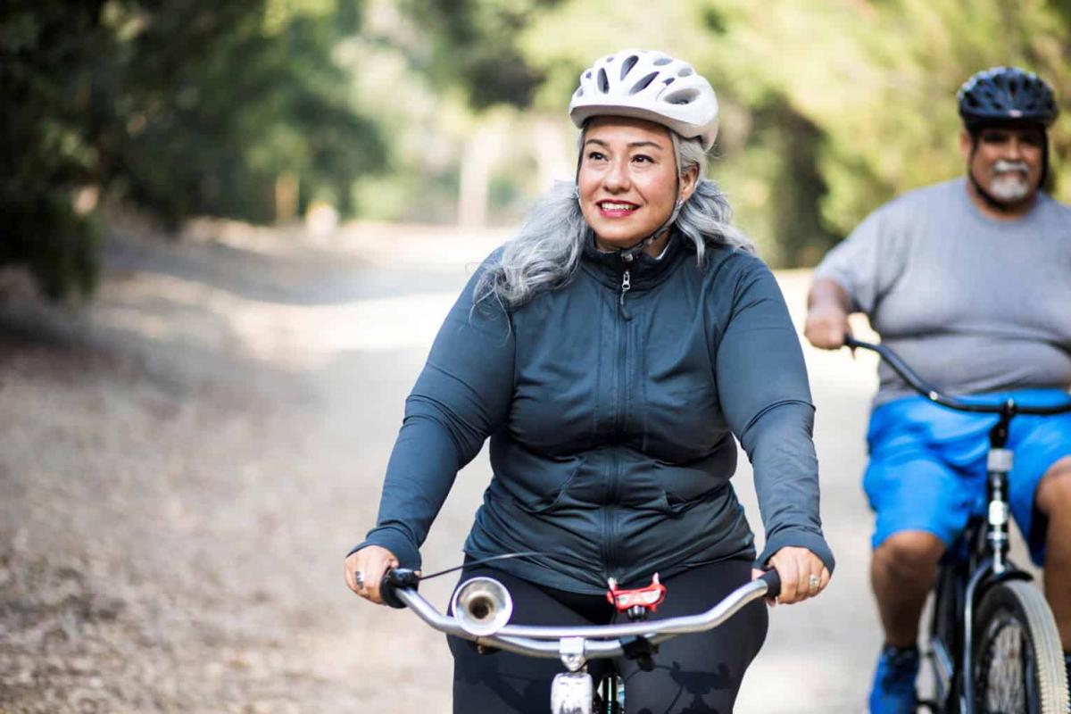 Seniors On Bikes With Helmets
