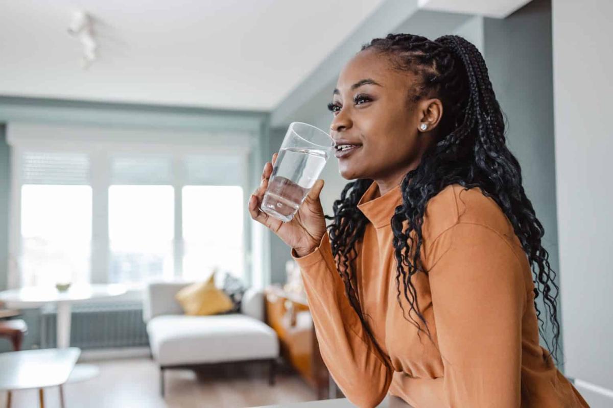 Black Young Woman Drinking Water