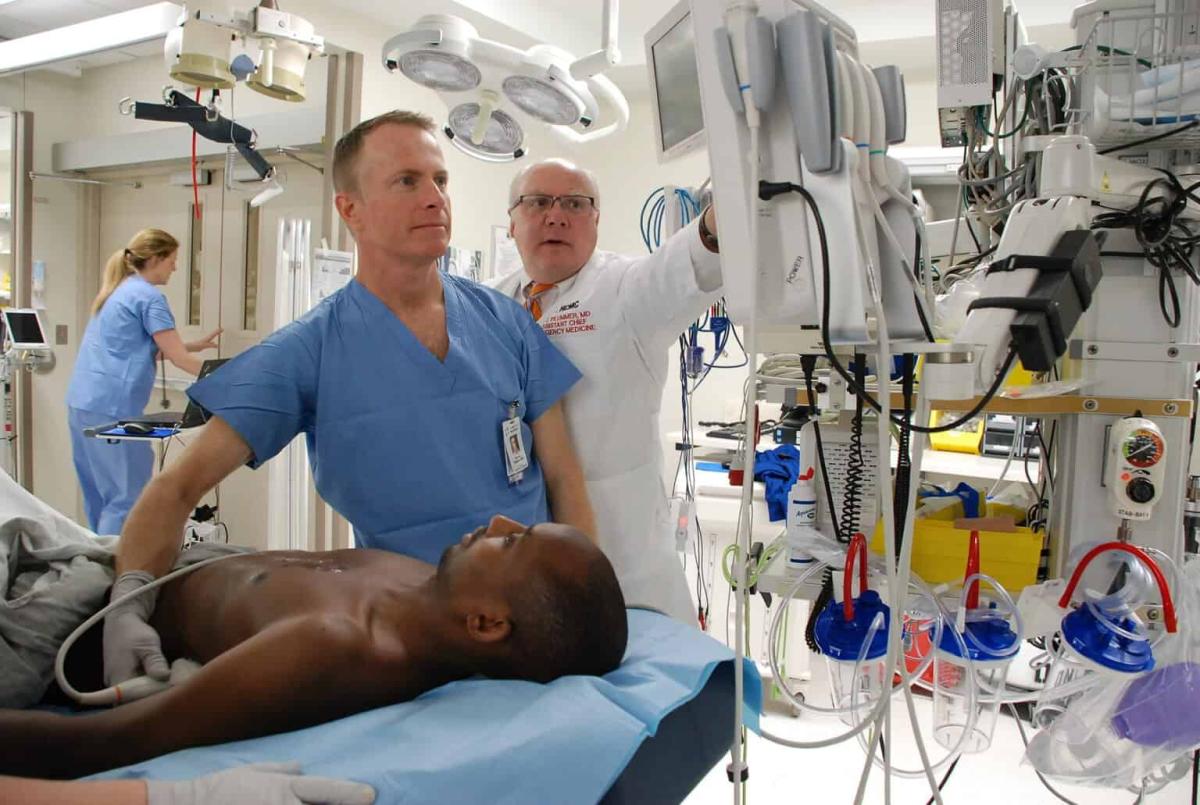 emergency medicine physician with patient in the STAB room, Hennepin Healthcare physicians, pioneers in ultrasound technology, point of care ultrasound, Dave Plummer, MD, Principles of Emergency Ultrasound and Echocardiography