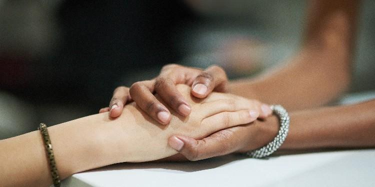 two women hold hands to support each other, miscarriage, 10 things to do when you have a miscarriage, we don't talk about miscarriages, 5 responses to someone having a miscarriage, emotional support, miscarriage for mothers of angels, megan hladilek