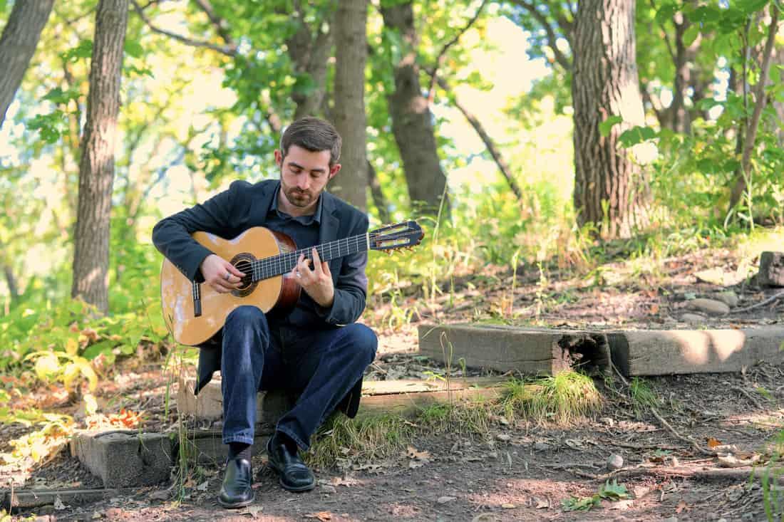 daniel volovets playing guitar in the woods, opera performer, psychiatry resident daniel volovets, flamenco guitar, romani roots, minnesota opera